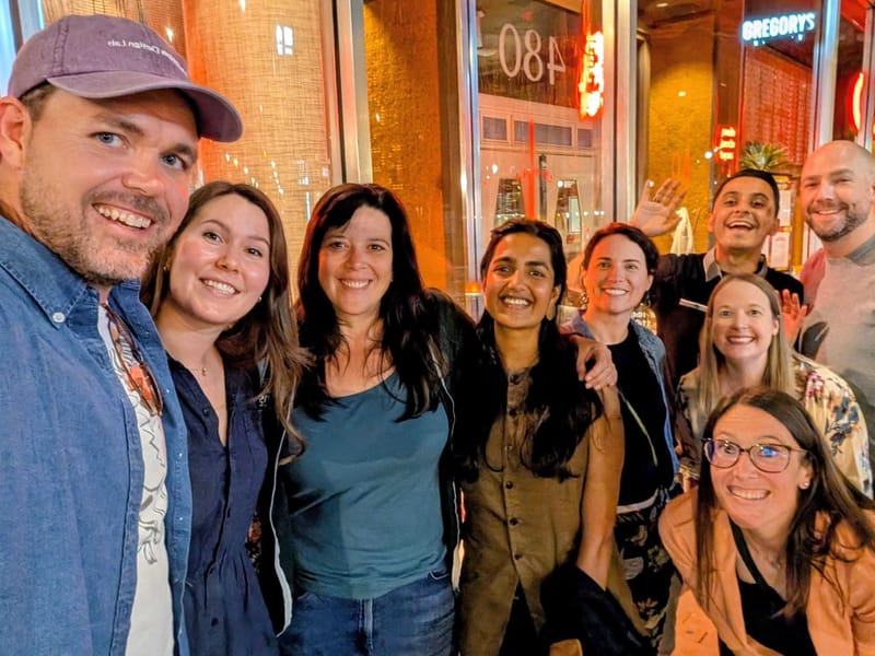 Education Design Lab staff together outside a restaurant in the evening during Home Week